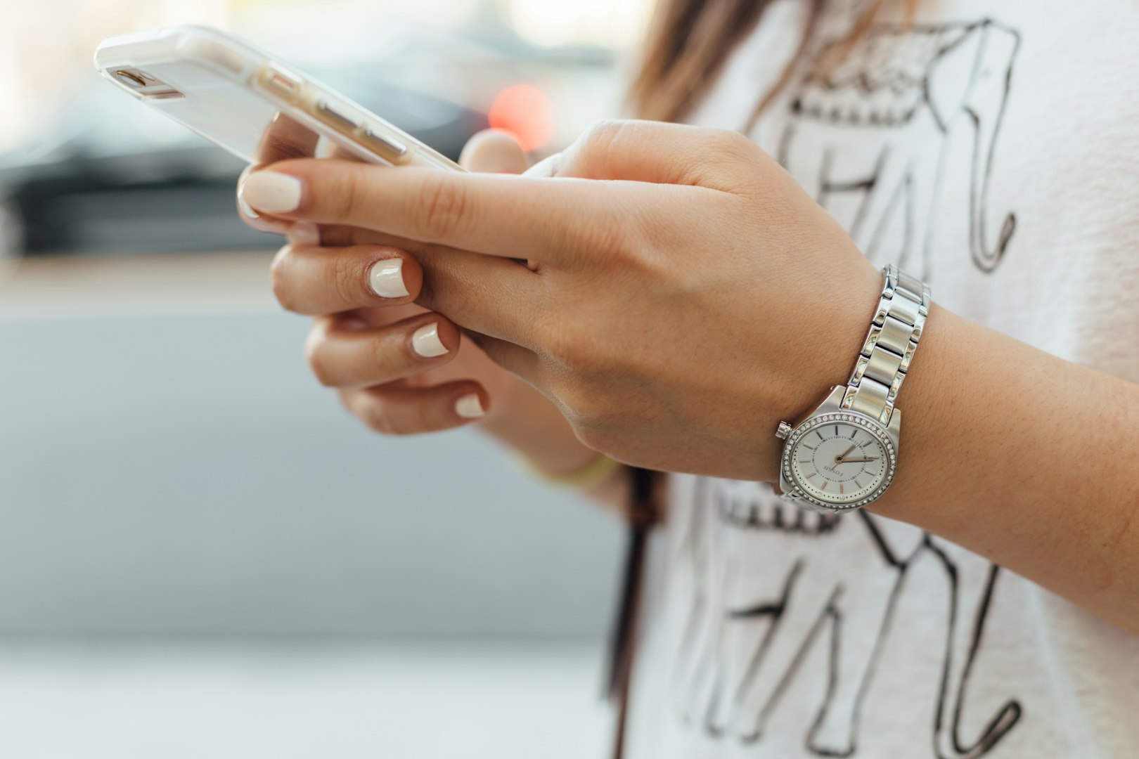 woman wearing a watch, holding a phone
